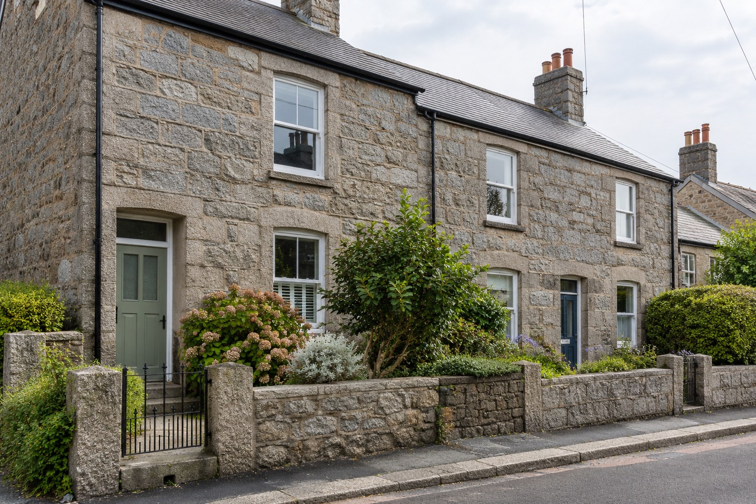 Granite terraced houses with slate roofs, painted front doors and small front gardens